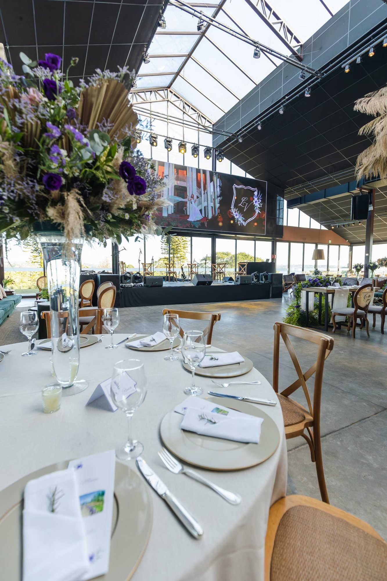 A wedding reception table set with floral arrangements and place settings