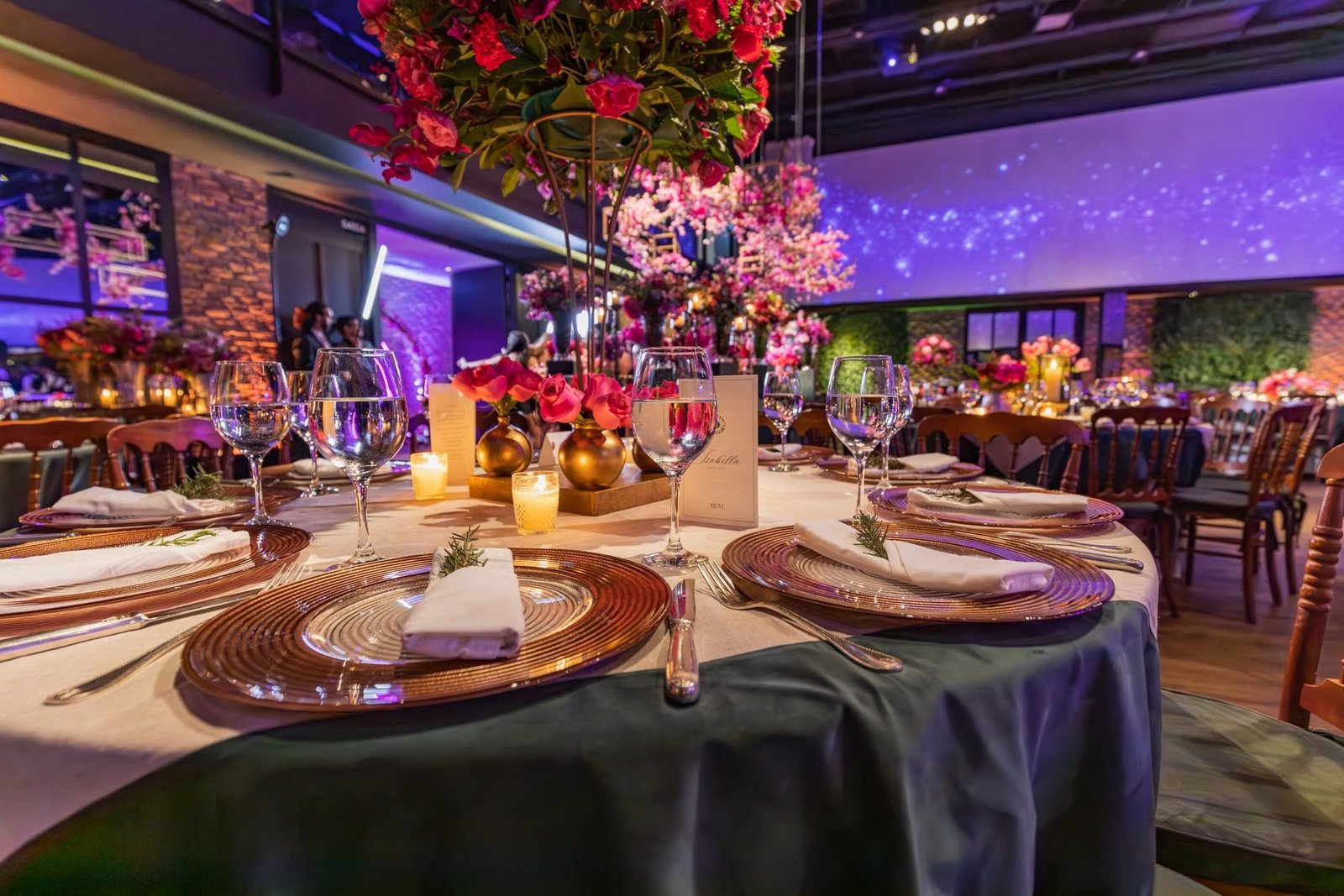 A close view of an elegantly laid banquet table with glassware and folded napkins